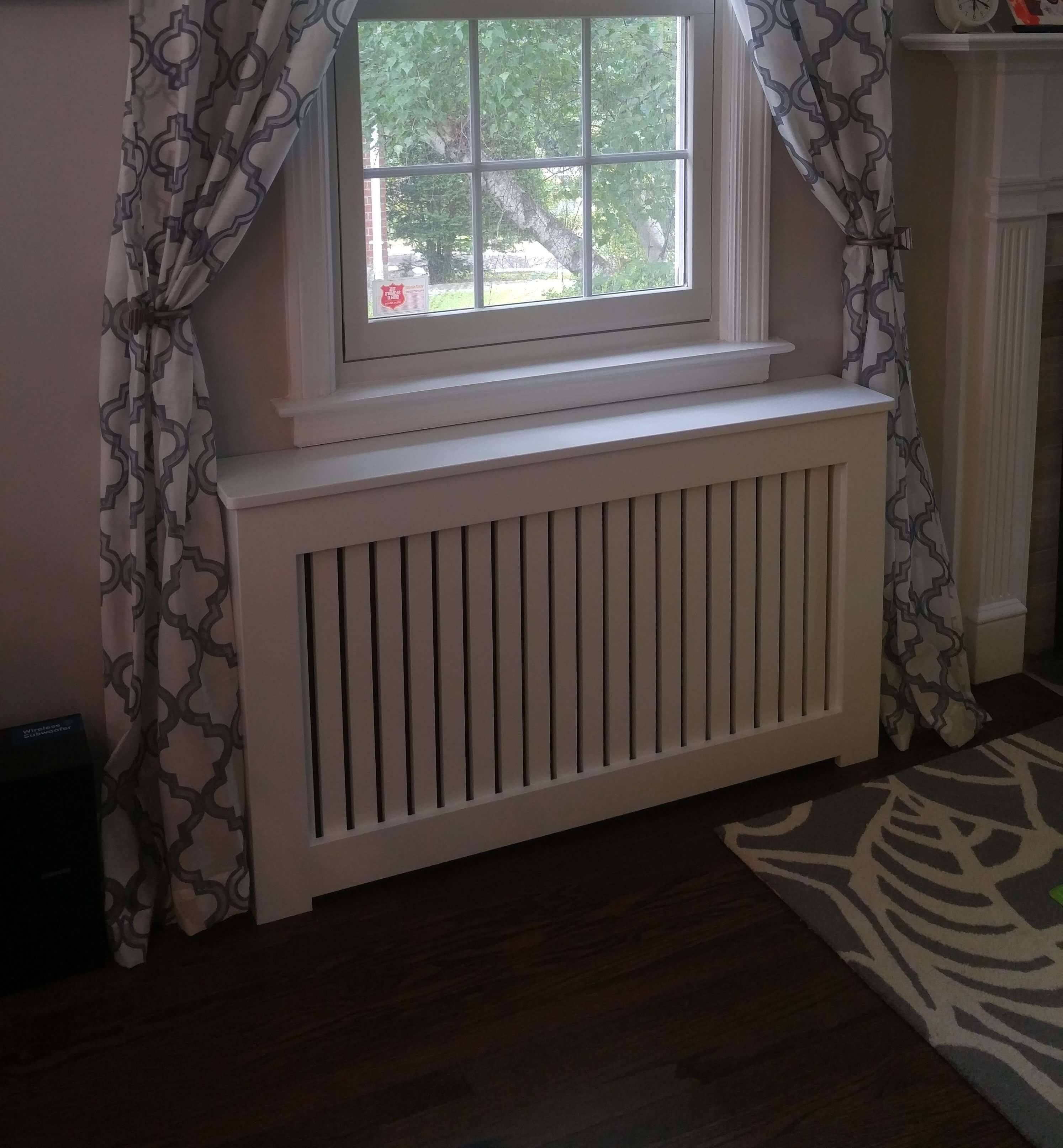 Shaker radiator cover with rounded edges and 1/2-inch gap between the slots under a living room window. 