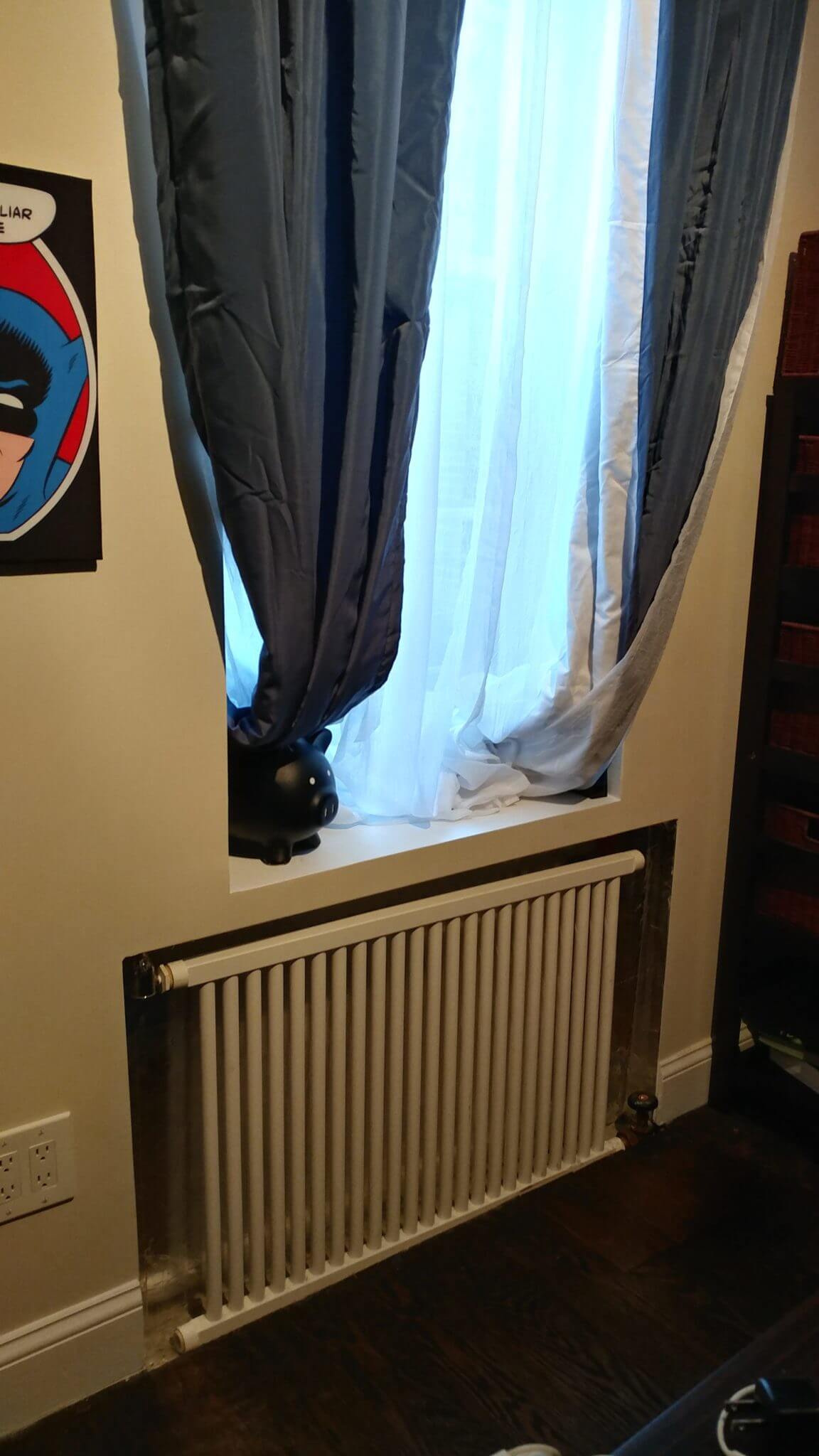 exposed metal radiator under a window