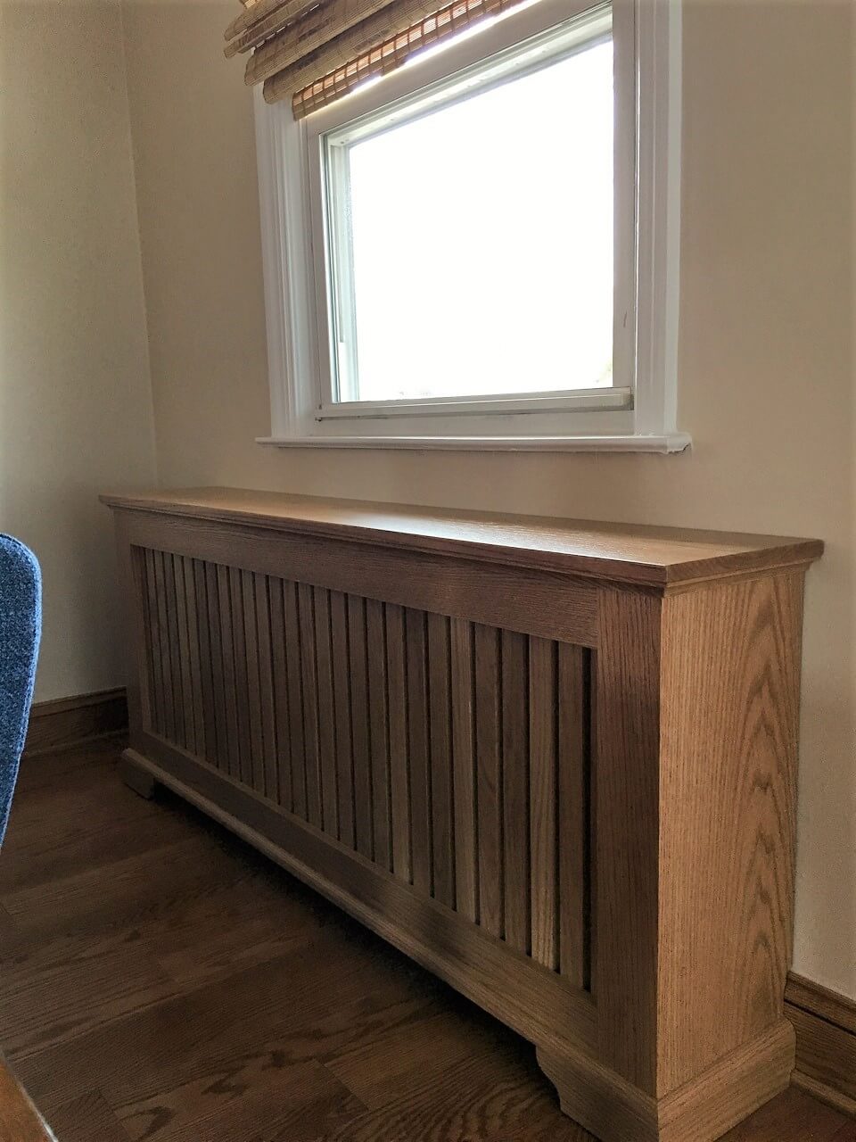 Living Room with cast iron radiator cover by a red oak stained radiator cover. 