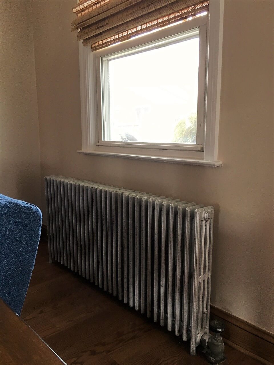 Living Room with exposed cast iron radiator 
