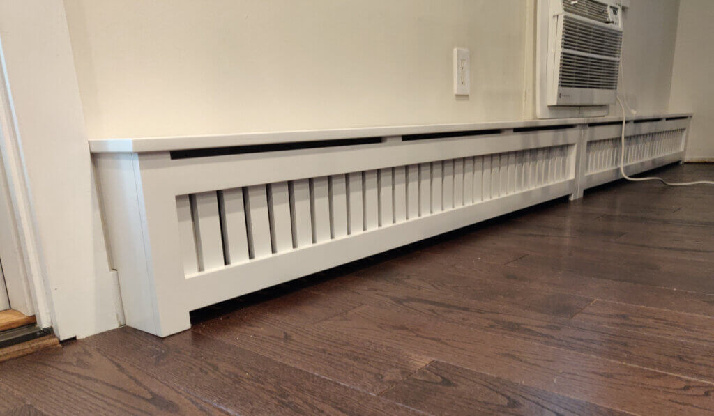 Shaker baseboard cover with 1/2  top vent installed on long wall